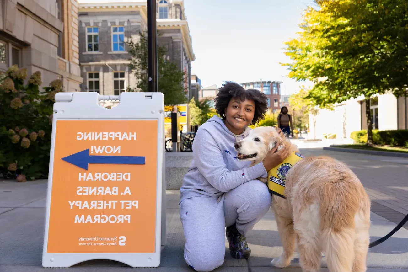 A student with a therapy dog.